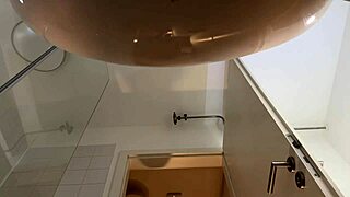 Look at this big tits babe doing a striptease in the bathroom with pantyhose and heels