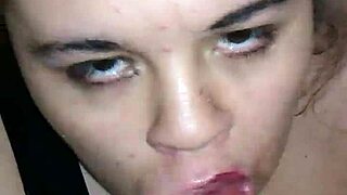 A woman performs oral sex on a large penis