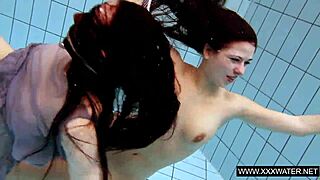 Explore this shaved brunette with big tits underwater in the pool! 🌊🍑