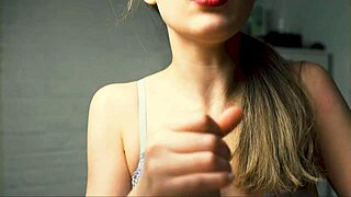 A beauty with red lips jerks off her boyfriend in close-up and brings him to the peak of pleasure