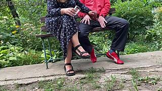 hot milf jerks off big dick into glass on park bench