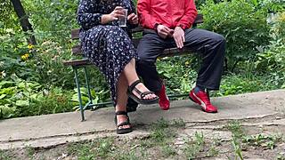 hot milf jerks off big dick into glass on park bench