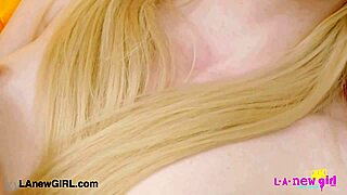 glistening blonde beauty shows her sexy body on sofa