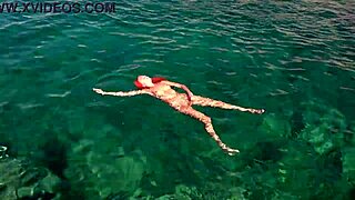 a skinny girl flashes her wet shaved pussy in blue water