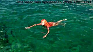 a skinny girl flashes her wet shaved pussy in blue water