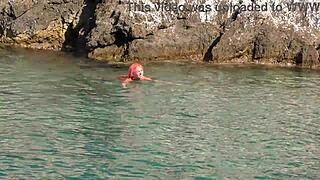 a skinny girl flashes her wet shaved pussy in blue water