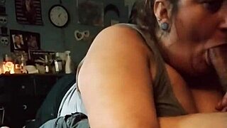 This redhead MILF is sucking a big cock and getting a titty fuck.