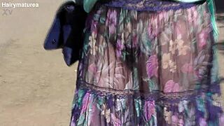 hairy mature woman in transparent dress flashing outdoors