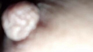 Latte flows from the nipples of a brunette with natural tits