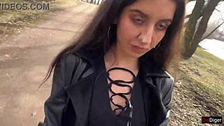 A girl has cum on her face and walks through the park to surprise onlookers.