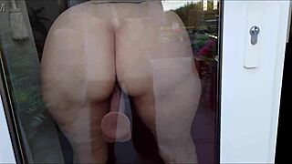Housewife Fucks Dildo Against Window