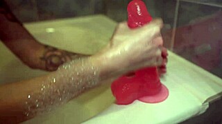 Cute girl jerks off her tight pussy with a big dildo in the bedroom.