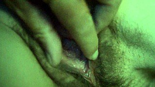 She plays with her pussy in dim light