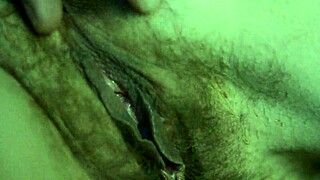 She plays with her pussy in dim light