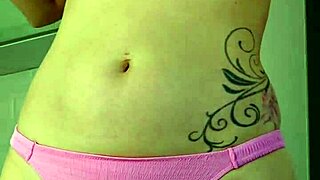 Woman rubs suncream on body during public sunbathing