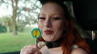 Submissive woman crawls from lagoon in humiliation scene.