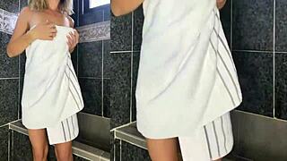 Nurse bathes patient in hospital shower.