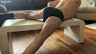 Aggressive myofascial pressure and release stretching on table in underwear with percussion massager