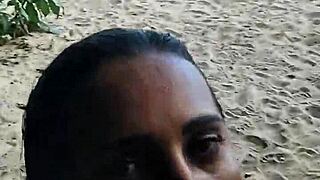 exhibitionist couple engages in public beach intimacy with stranger joining for shared climax