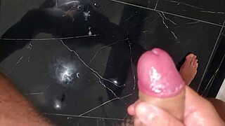 Ansima moans while spitting on big cock during intense handjob.