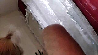 mature slut wife in a red satin negligee with a ponytail on her head and a dick in her mouth