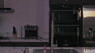 Sara Jay plays with her dildo in the kitchen, showing off those big tits