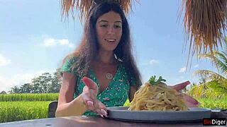 Walking in public cafe while eating pasta carbonara with white sauce on face