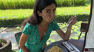 Walking in public cafe while eating pasta carbonara with white sauce on face