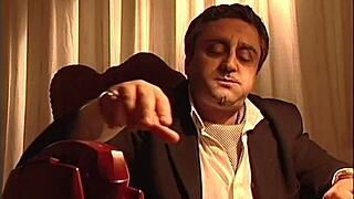 Jasmine Rouge gives a teasing blowjob under the desk to the mafia boss, swallowing his cum.