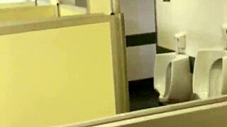 A person assists in the public restroom of a movie theater