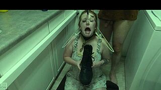 The redhead slut eagerly licks cum off her dominatrix's boot in this BDSM scene.