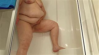 Big boobed BBW MILF maid in mini dress cleans house, showers, flashes pussy close up upskirt