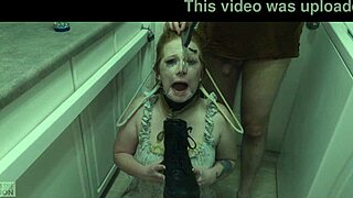 The redhead slut eagerly licks cum off her dominatrix's boot in this BDSM scene.