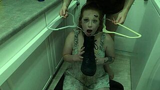 The redhead slut eagerly licks cum off her dominatrix's boot in this BDSM scene.