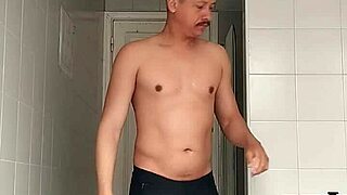 guy in black beach shorts shaves smooth in intriguing bathroom reveal