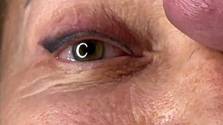 Mature cougar milf milks young stud's monster cock with handjob then takes huge facial cumshot on eyes and face