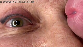 Mature cougar milf milks young stud's monster cock with handjob then takes huge facial cumshot on eyes and face