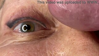 Mature cougar milf milks young stud's monster cock with handjob then takes huge facial cumshot on eyes and face