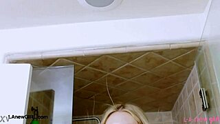 elegant shy blonde steps into the shower for a relaxing rinse