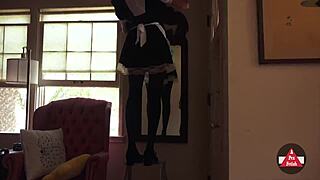Sexy French maid in stockings and skirt vacuums seductively, upskirt flashing her model curves while cosplaying cleaning lady.