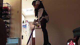 Sexy French maid in stockings and skirt vacuums seductively, upskirt flashing her model curves while cosplaying cleaning lady.
