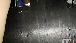 A blonde meets strangers through gloryhole while partner watches nearby