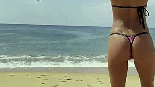 monika fox flaunts pink starry bikini along sun-kissed beach