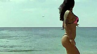 monika fox flaunts pink starry bikini along sun-kissed beach