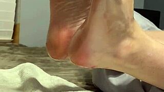 oiled milf spreads toes wide, begging for fetish foot worship on her scrunched soles