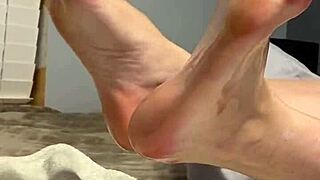 oiled milf spreads toes wide, begging for fetish foot worship on her scrunched soles