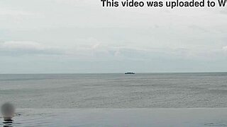 college japanese princess skinny with ponytail relaxes at infinity pool