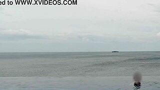 college japanese princess skinny with ponytail relaxes at infinity pool