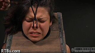 girl strips teasingly inside tight cage as clothes rip off slowly