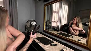 Tattooed blonde does hair and makeup naked
